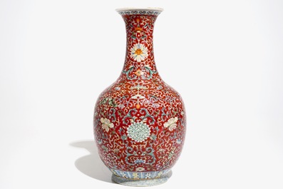 A Chinese red-ground famille rose bottle vase, Qianlong mark, 19/20th C.